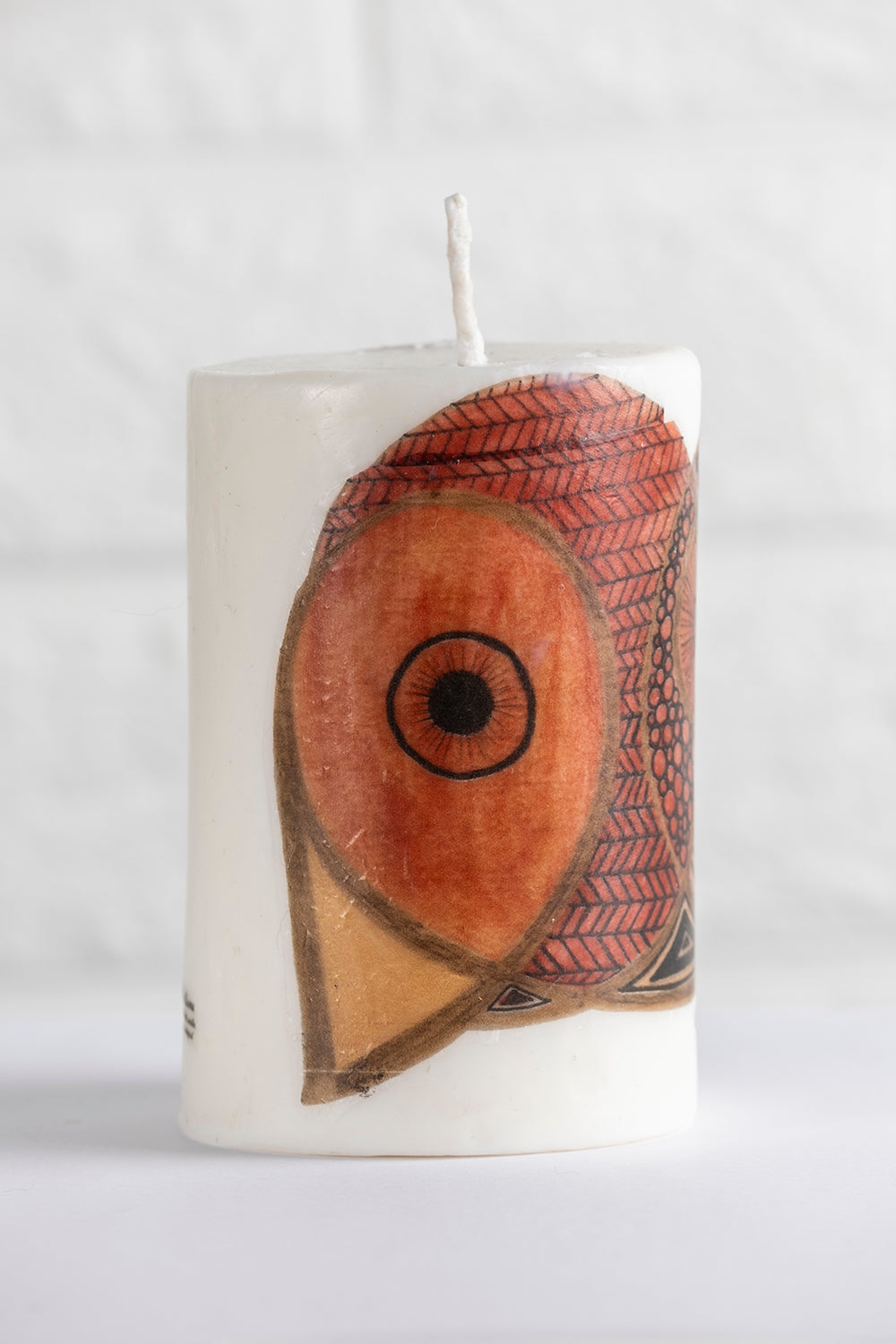 White vegetable wax pillar candle with no aroma and drawing